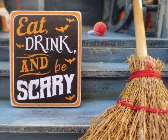 witches' broom and Halloween sign on doorstep